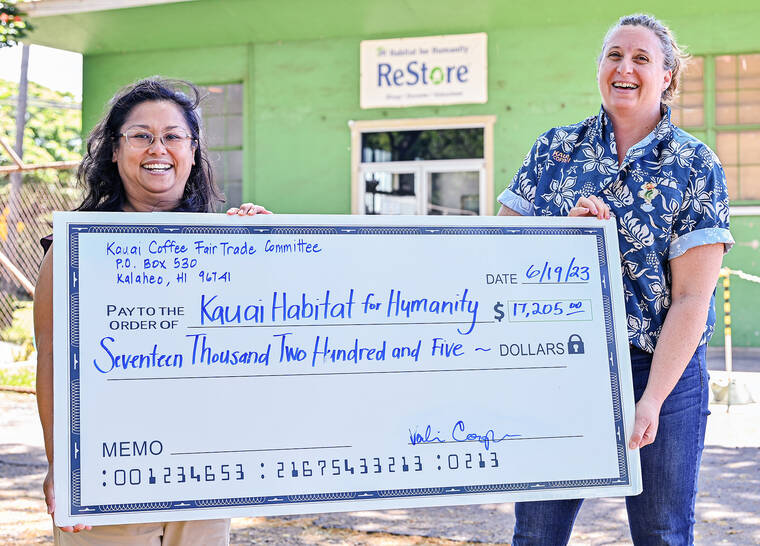 Kauai coffee fair trade committee presents habitat for humanity with large check