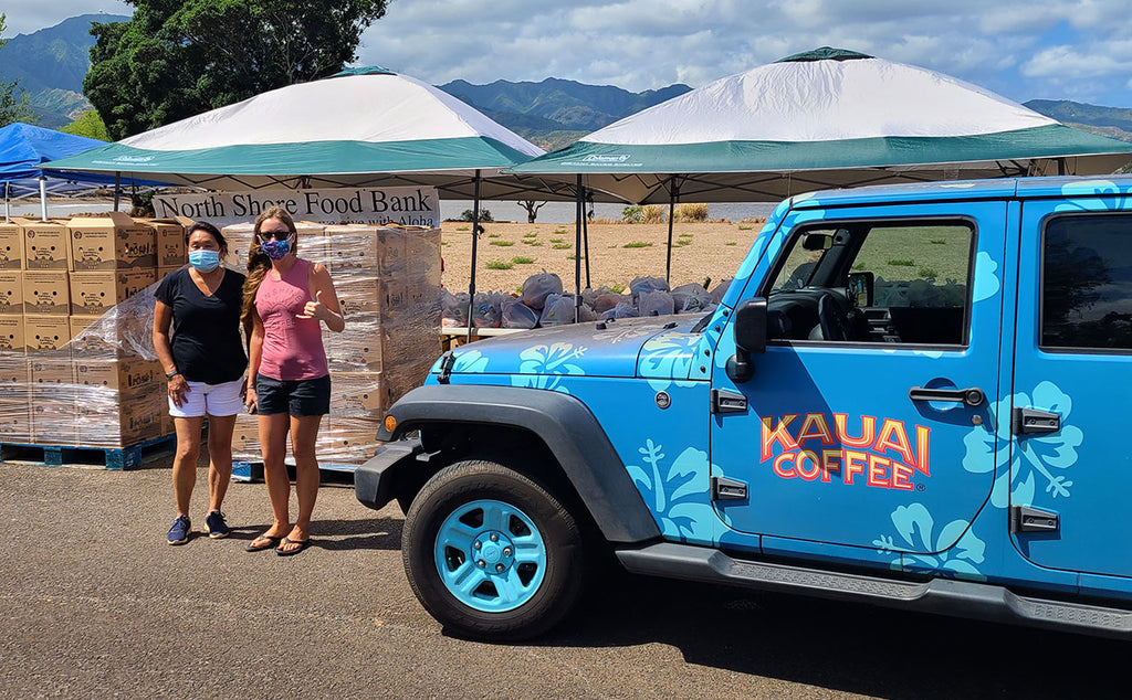 kauai coffee donates to the north shore community food bank distribution on oahu, kauai coffee staff serving the community by volunteering at food distribution,