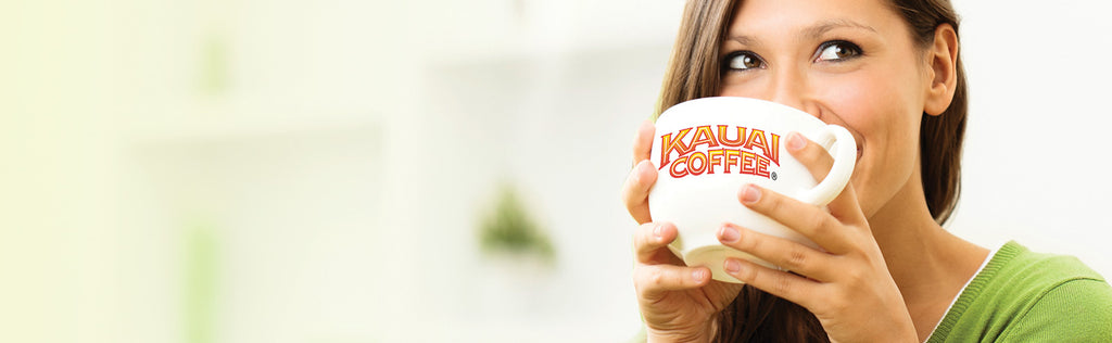 Woman drinking a cup of Kauai Coffee